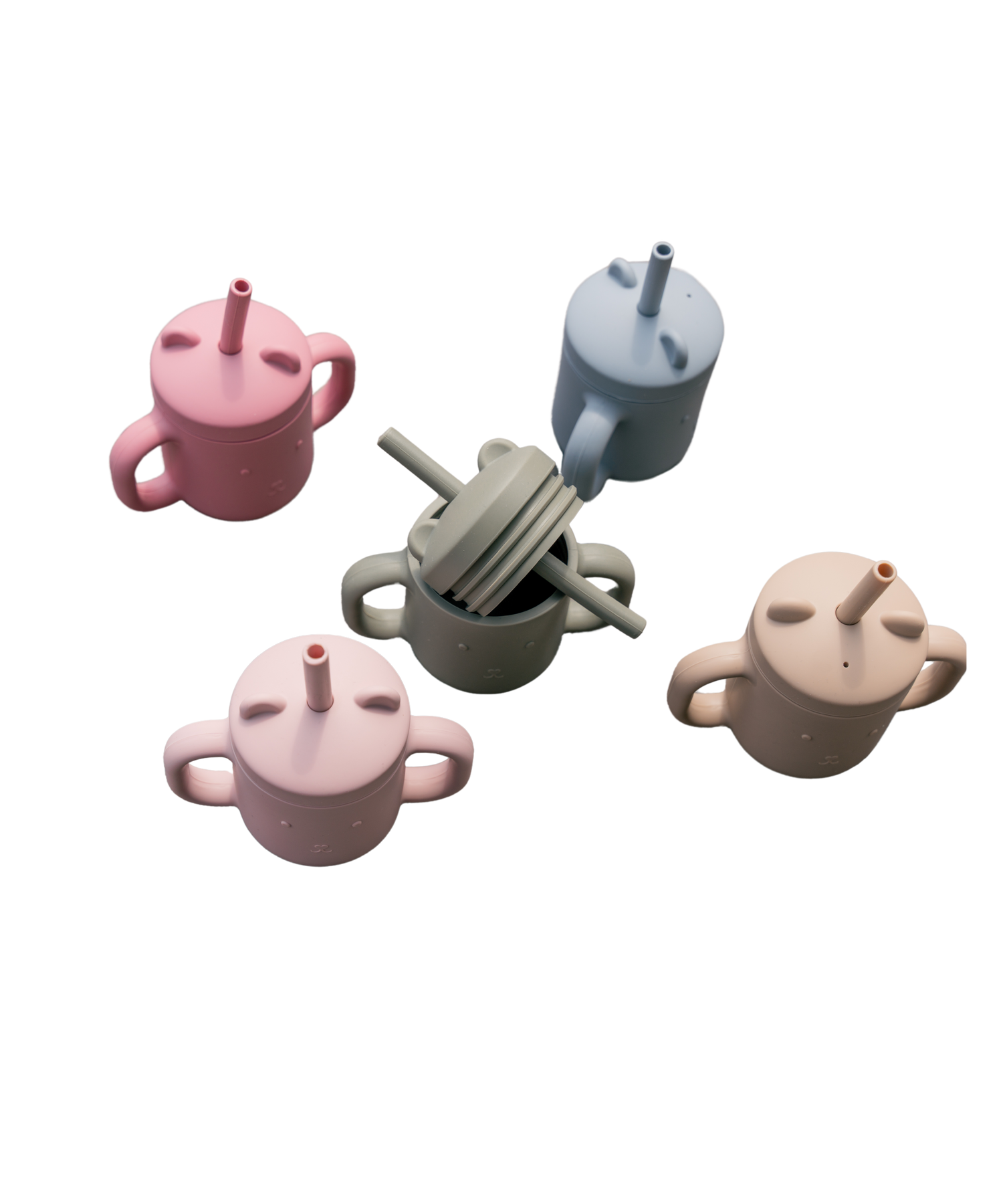 Silicone sippy cups with straws in five colors, shown from above