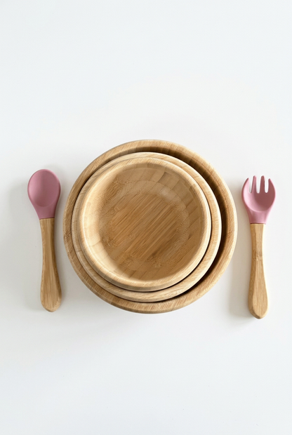 Nested bamboo bowls with pink utensils